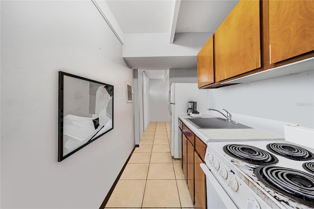 kitchen with white range oven, sink, and light tile patterned flooring