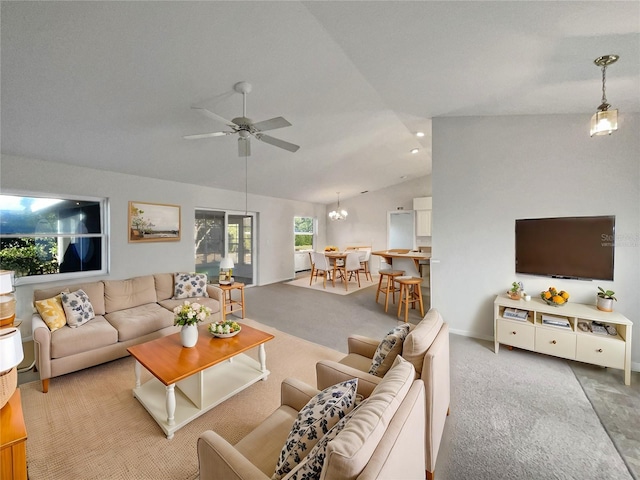 living room featuring carpet flooring, ceiling fan with notable chandelier, and vaulted ceiling