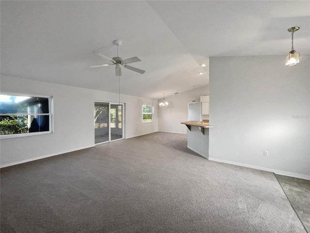 unfurnished living room featuring carpet, ceiling fan with notable chandelier, and lofted ceiling