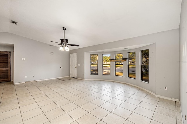 tiled spare room featuring ceiling fan and vaulted ceiling