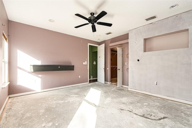 interior space with a walk in closet, ceiling fan, and a closet