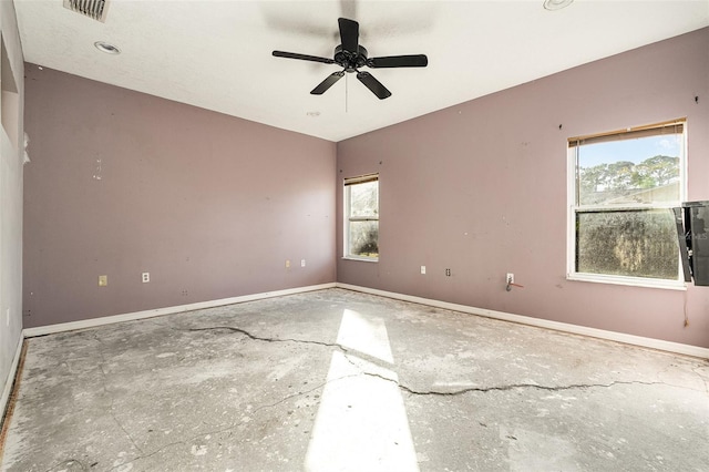 unfurnished room featuring plenty of natural light and ceiling fan