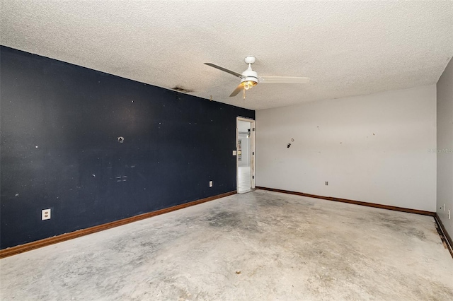 empty room featuring ceiling fan, a textured ceiling, and concrete floors