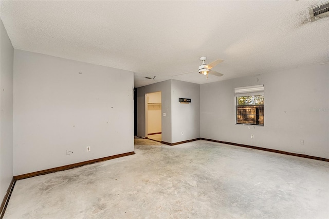 unfurnished room with ceiling fan and a textured ceiling