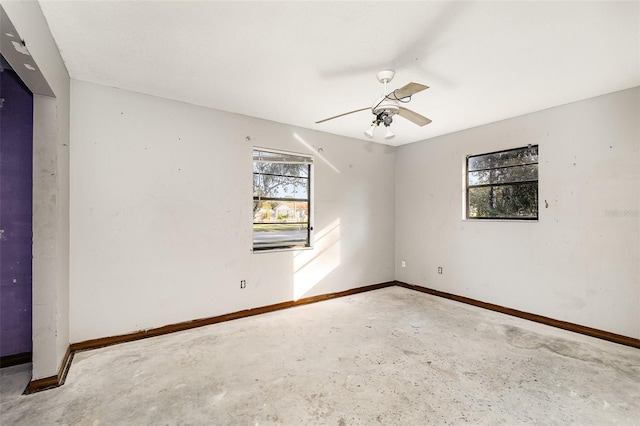 empty room featuring ceiling fan and concrete floors