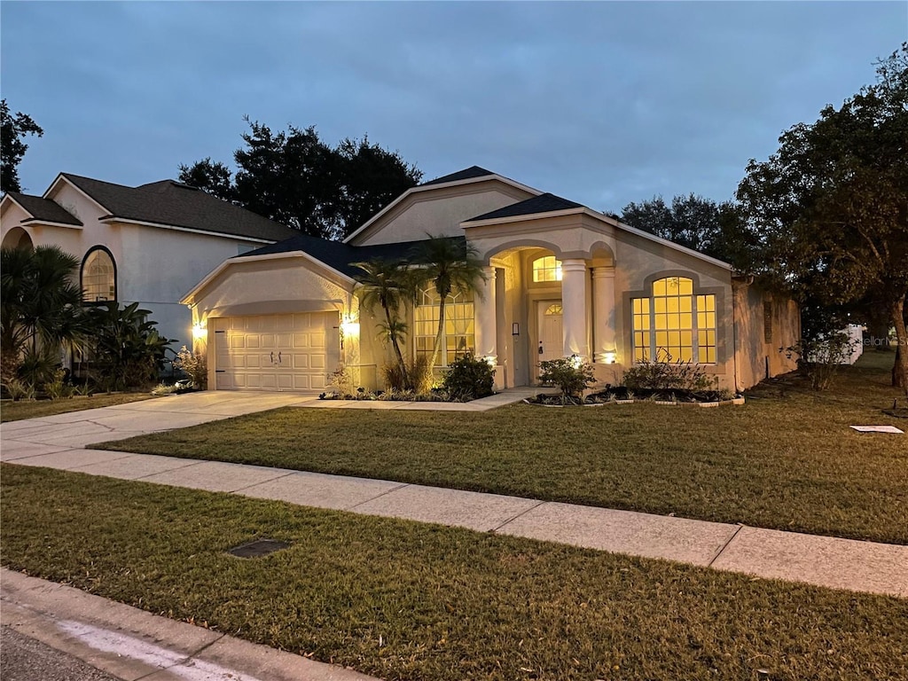 view of front of home featuring a front yard and a garage