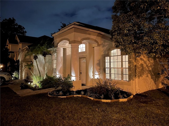 view of exterior entry at night