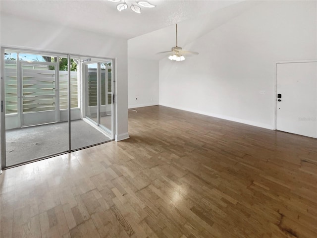 empty room featuring hardwood / wood-style floors, ceiling fan, and lofted ceiling