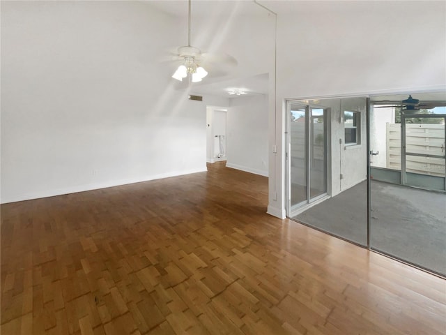 unfurnished room featuring ceiling fan, dark hardwood / wood-style flooring, and high vaulted ceiling