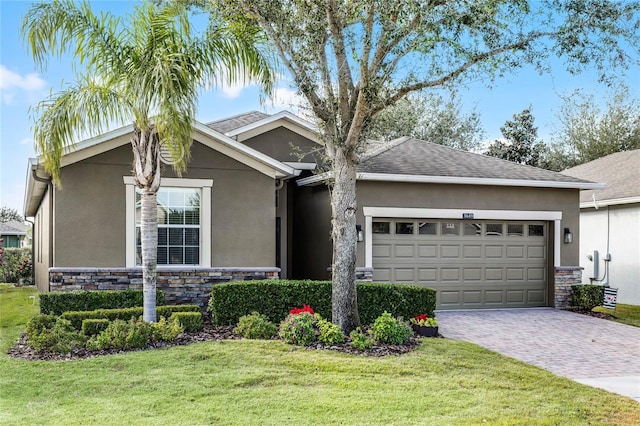 view of front of house with a front yard and a garage