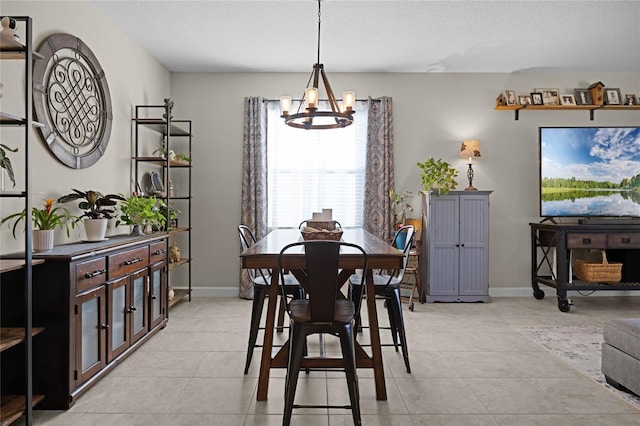 tiled dining space featuring a textured ceiling and an inviting chandelier