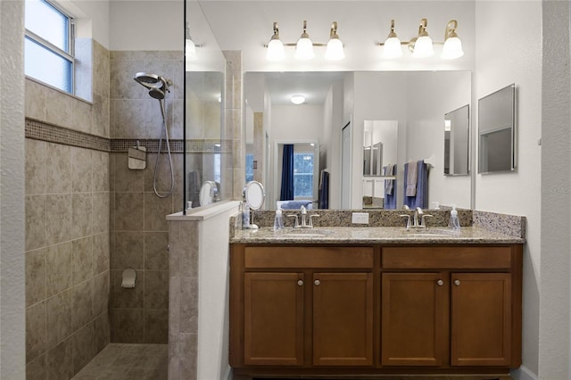 bathroom featuring vanity and tiled shower