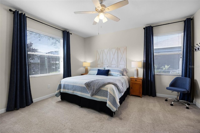 carpeted bedroom featuring ceiling fan and multiple windows