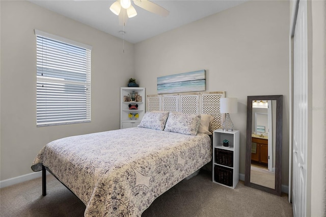 carpeted bedroom with connected bathroom and ceiling fan