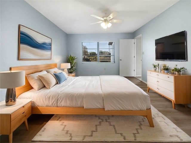 bedroom with ceiling fan and dark wood-type flooring