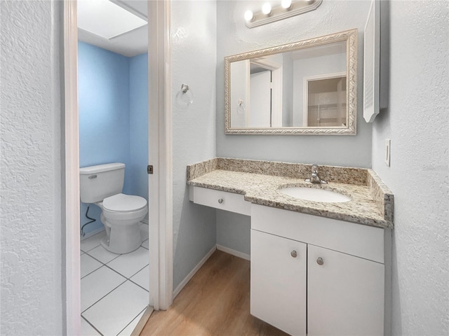 bathroom featuring hardwood / wood-style floors, vanity, and toilet