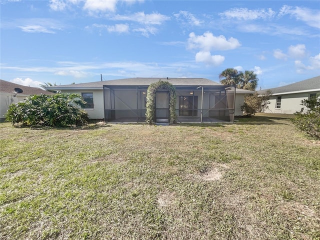 rear view of house featuring a lawn and a lanai