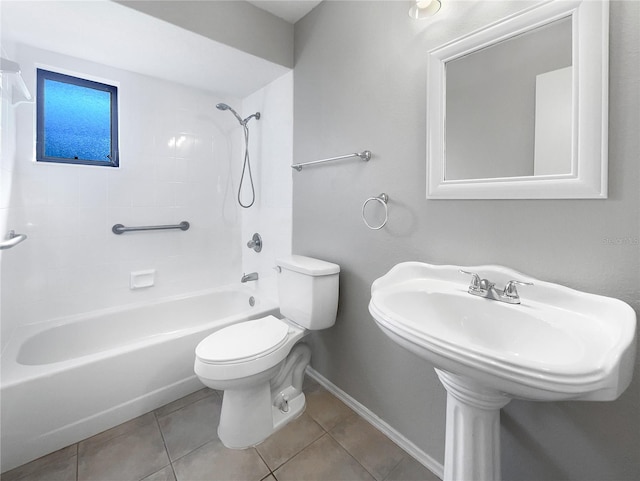 bathroom featuring tile patterned flooring, tiled shower / bath combo, and toilet