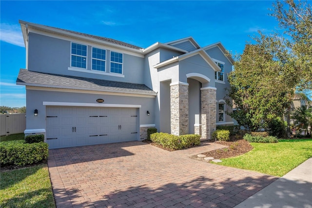 view of front facade with a front yard and a garage