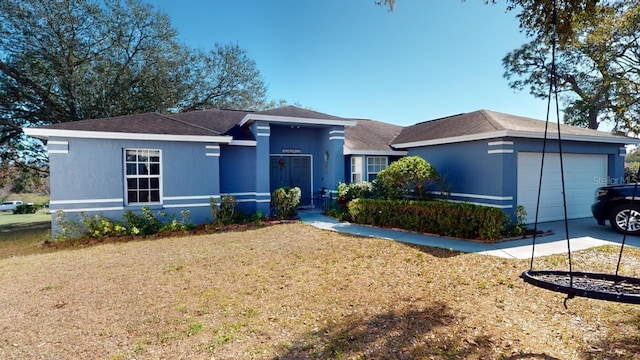 view of front facade featuring a garage and a front lawn