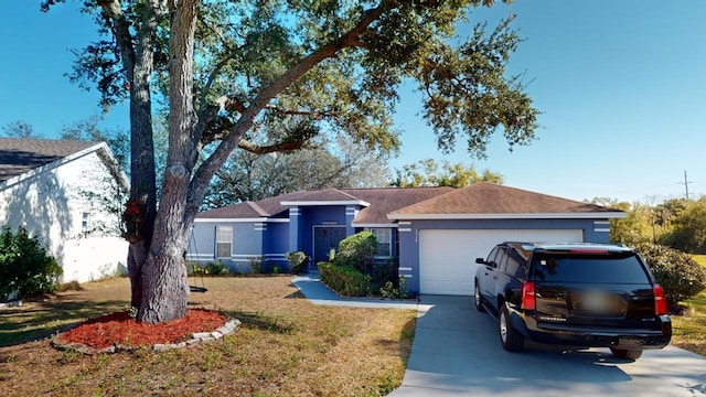 ranch-style home featuring a garage and a front lawn