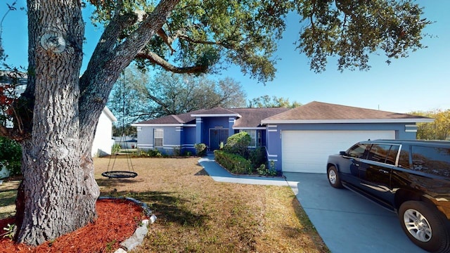 single story home featuring a garage and a front yard