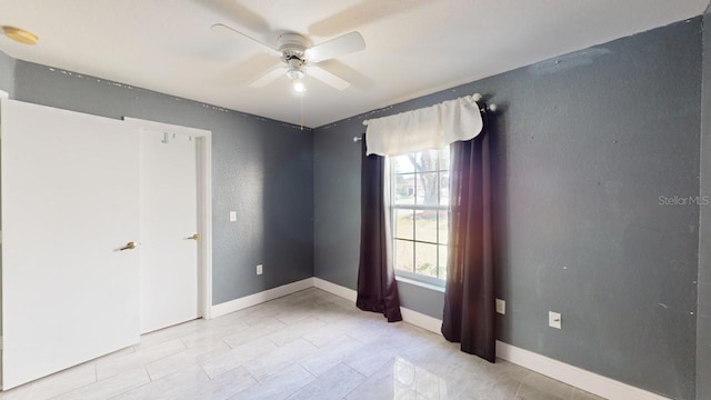 unfurnished room with ceiling fan