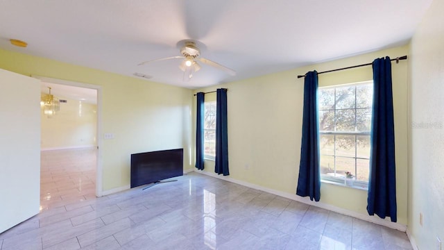 unfurnished living room featuring light tile patterned floors and ceiling fan