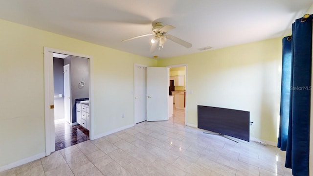 unfurnished bedroom featuring connected bathroom, ceiling fan, and light tile patterned floors