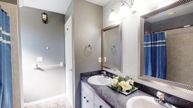 bathroom featuring vanity and curtained shower