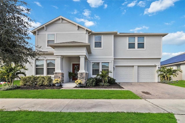 view of front of house featuring a front yard and a garage