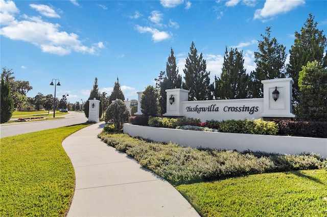 community sign featuring a lawn