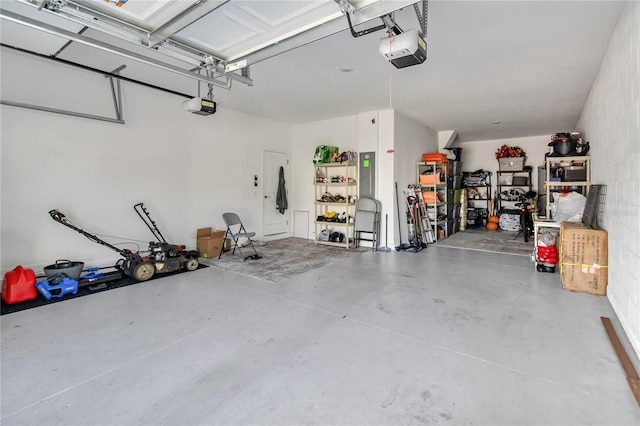 garage with a garage door opener and electric panel