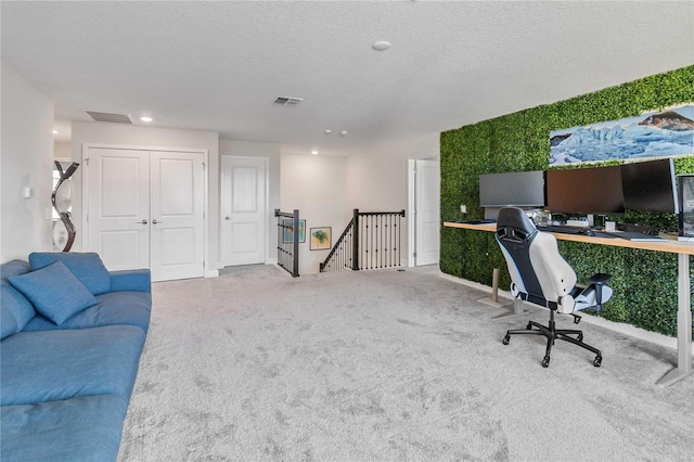 office featuring carpet floors and a textured ceiling