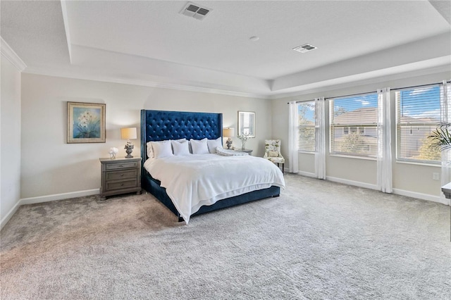 bedroom featuring a tray ceiling, carpet, and ornamental molding