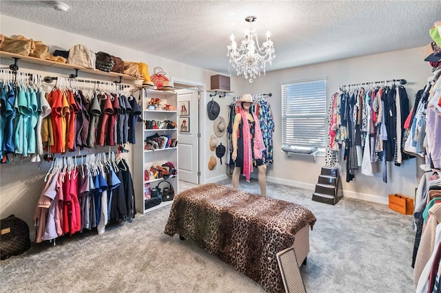 spacious closet featuring light carpet and a chandelier