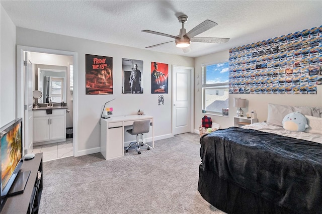 carpeted bedroom with a textured ceiling, ceiling fan, and connected bathroom