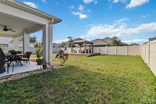 view of yard featuring a gazebo, ceiling fan, and a wooden deck