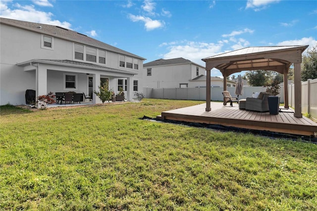 view of yard with a gazebo, an outdoor living space, and a deck