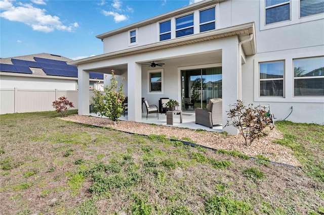 rear view of property with a yard, an outdoor hangout area, ceiling fan, and a patio area