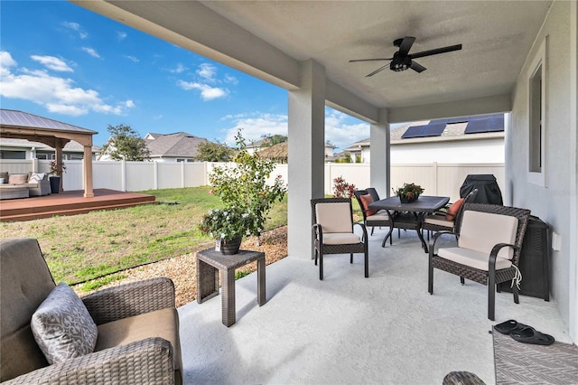 view of patio / terrace featuring area for grilling, ceiling fan, and a wooden deck