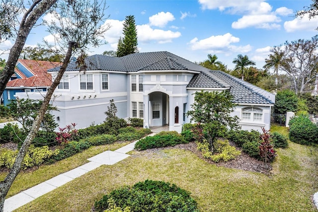 mediterranean / spanish-style home with a front yard