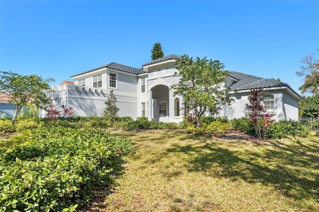 mediterranean / spanish-style house with a front lawn