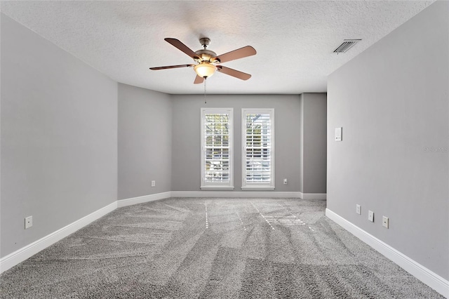 empty room with a textured ceiling, ceiling fan, and carpet flooring