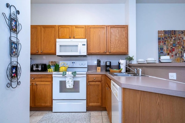 kitchen featuring light tile patterned flooring, sink, backsplash, and white appliances