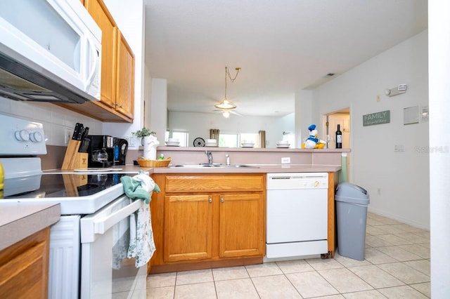 kitchen featuring sink, white appliances, light tile patterned floors, and backsplash