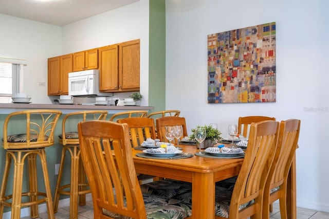 dining area featuring light tile patterned floors