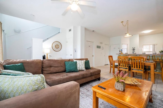 tiled living room featuring ceiling fan