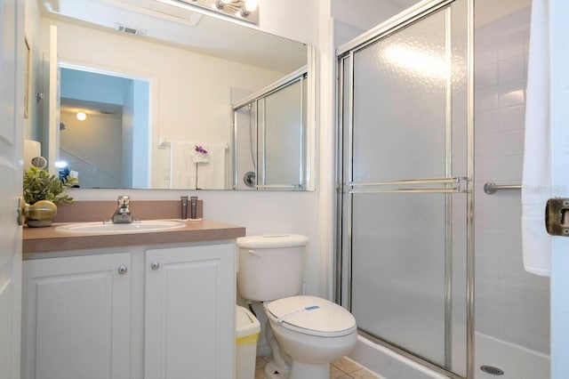 bathroom with vanity, toilet, and an enclosed shower