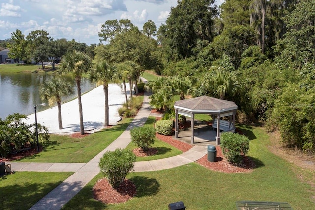 view of home's community with a water view, a gazebo, and a lawn